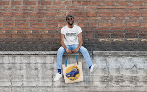 Man wearing Addis Ababa T-shirt and holding Ethiopian taxi tote bag