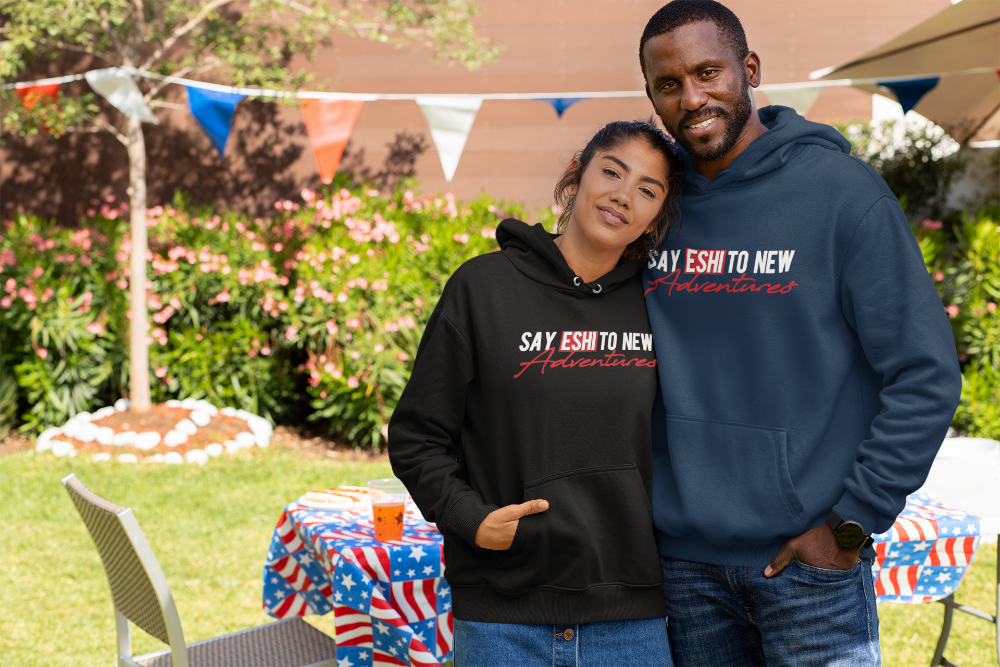Ethiopian couple wearing hoodie that reads Say Eshi to new adventures.
