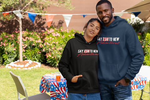 Ethiopian couple wearing hoodie that reads Say Eshi to new adventures.
